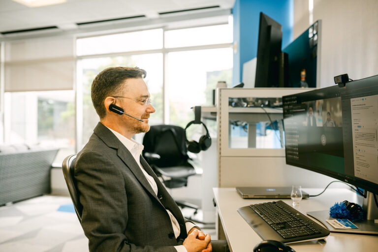 Charles IT tech with headset at computer in Stamford CT