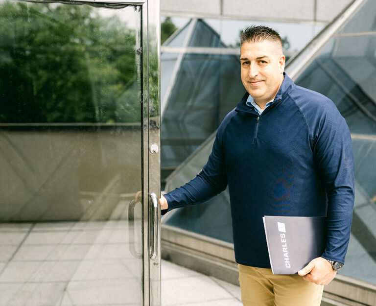 Professional man holding door to office open