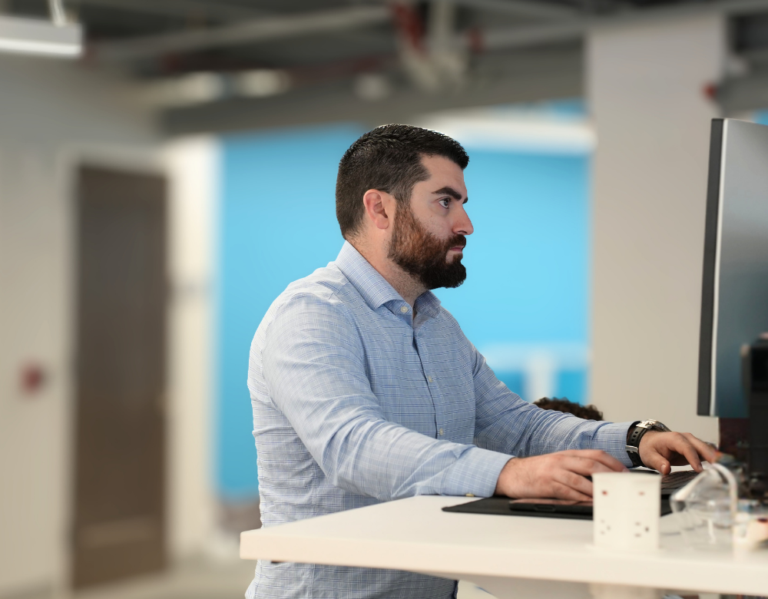 Charles IT cybersecurity professional working at a technology workstation