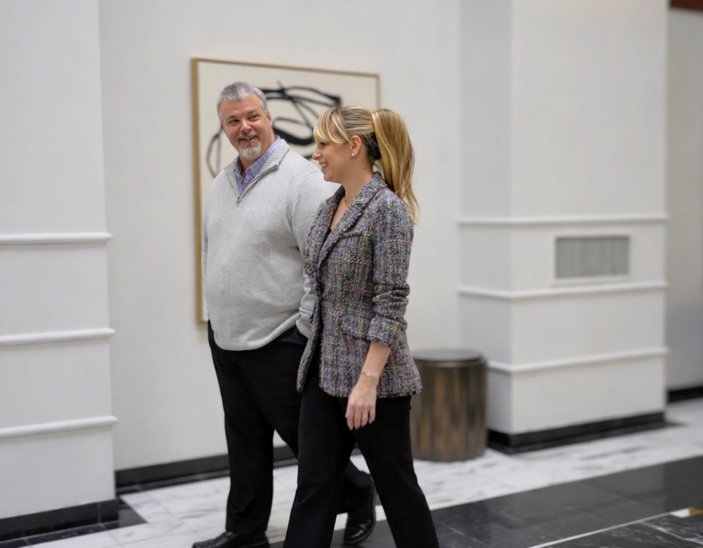 Two Charles IT team members walking and talking in the office