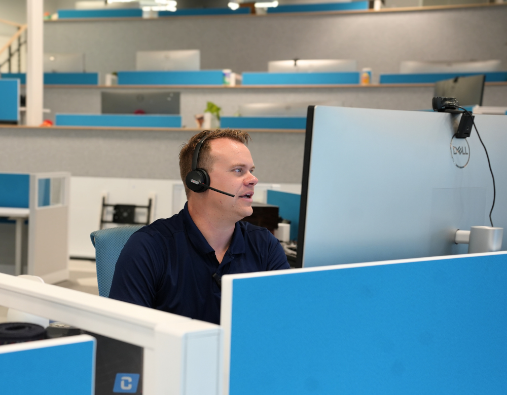 Charles IT Founder assisting a client by headset from the Middletown office