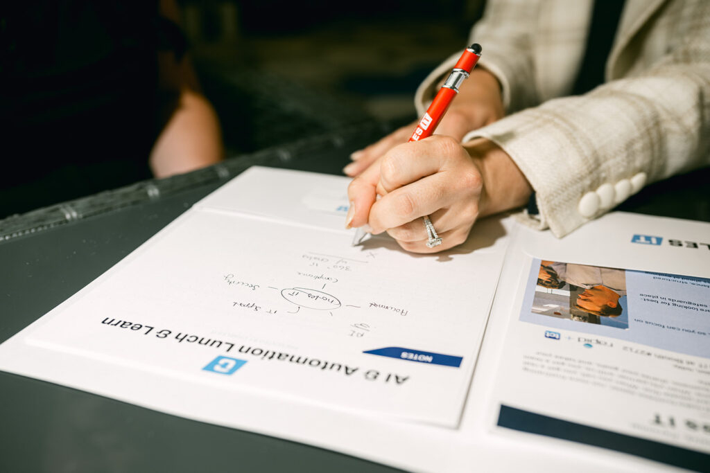 Professional taking notes during a business technology consultation
