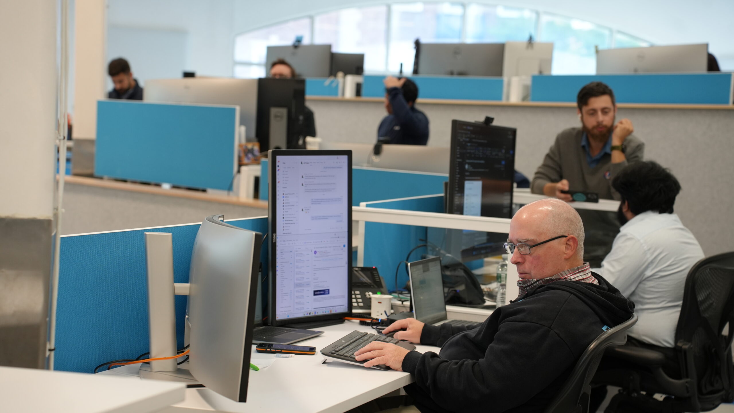 Professional reviewing secure login authentication on a computer screen in an office environment.