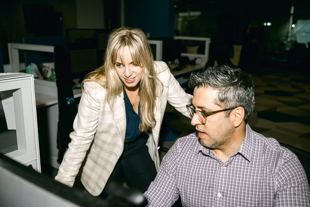 Charles IT professionals collaborating at a computer workstation
